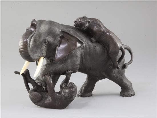 A Japanese bronze group of two tigers attacking an elephant, Meiji period, length 28cm height 18.5cm